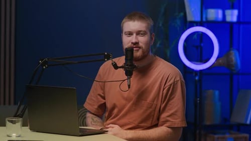 Young Radio Host Starting Podcast in Modern Recording Studio