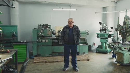 Machinist Stands in Industrial Machine Shop