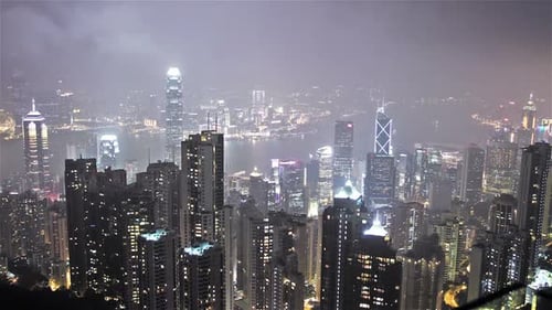 Hong Kong city skyline shimmers from victoria peak at twilight in time lapse
