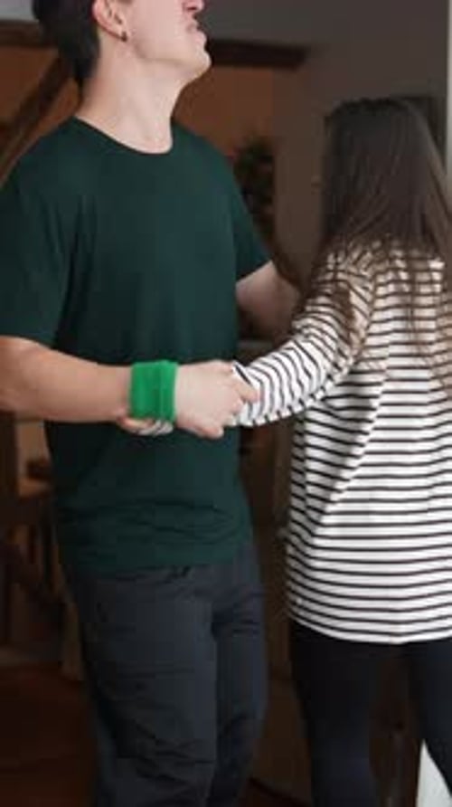 Young Couple Joyfully Dancing Indoors