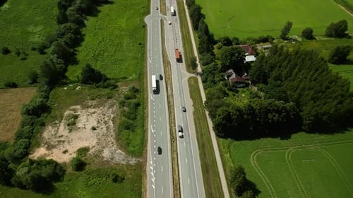 Film Vehicles in Motion on a Rural Highway with an Aerial View Using Drones or Other Means to