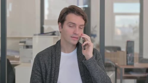 Young Adult Talking on Cellphone in Office