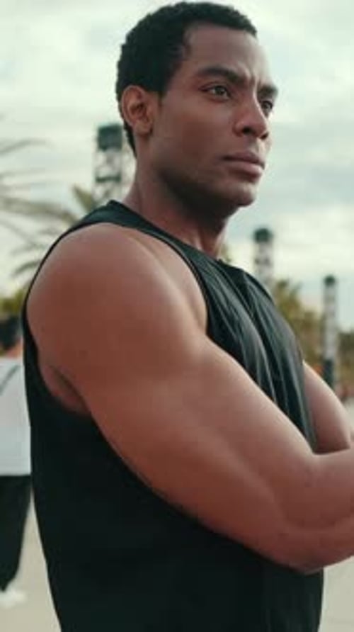 Vertical video, Athlete Stretching on Beach Promenade