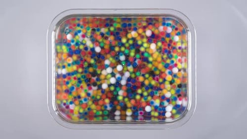 Container of Colorful Water Hydrogel Balls Overhead