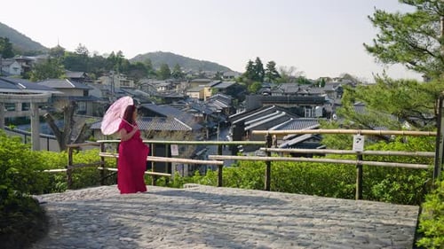 Female Traveler With Paper Umbrella Exploring View From Yasaka Pagoda Viewpoint In Kyoto, Japan. dol