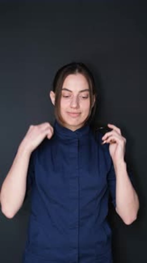 Female Putting on a Stethoscope in Studio