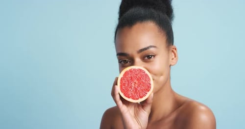 Skincare, makeup and grapefruit black woman model with organic beauty cosmetics product for wellness