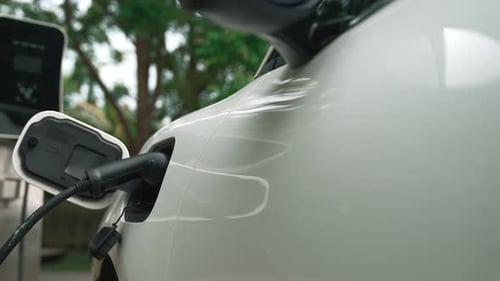 Closeup Progressive Concept of Electric Car Being Charged at Charging Station
