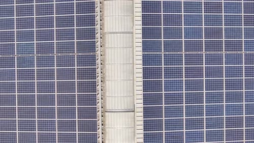 Close-up view of solar panels on an industrial building roof