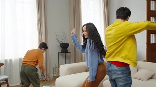 Happy Family Dancing Together in Living Room