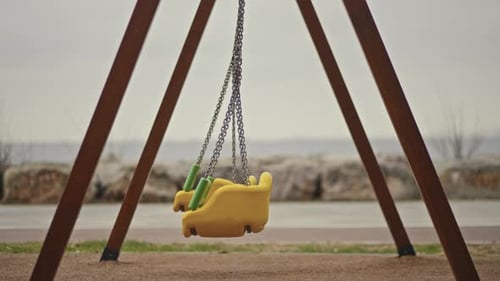 Lonely Swing Swaying in a empty park.
