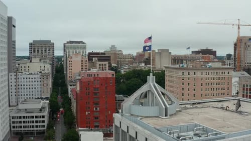 Aerial View of City Buildings with Flags