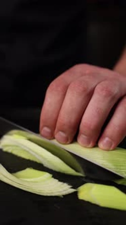the chef cuts vegetables in a restaurant