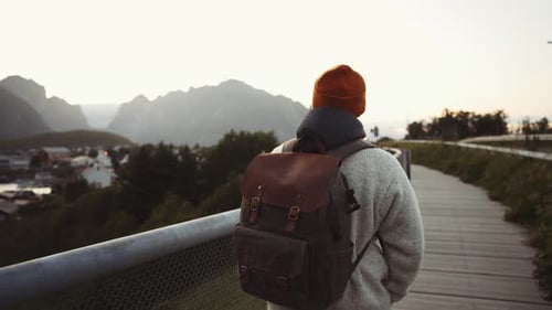 Hiker with Backpack Enjoying Lofoten's Landscape in Norway