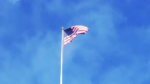 American Flag Waving on a Pole, Blue Sky