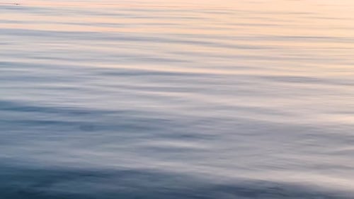 Closeup of Blue Sea Water with Ripples During Golden Hour: A Tranquil Seascape