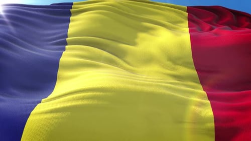 Vibrant Romanian Flag Waving Against Clear Blue Sky