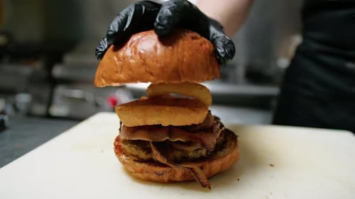 Chef Assembles Gourmet Burger in Restaurant Kitchen