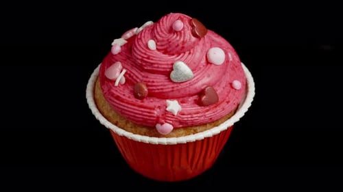 Delicious Cupcake with Pink Frosting and Heart Decorations