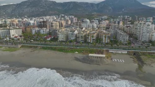Aerial Video Majestic Storm Waves Roll Onto the Beach Leaving Shimmering Foam Along the Coastline