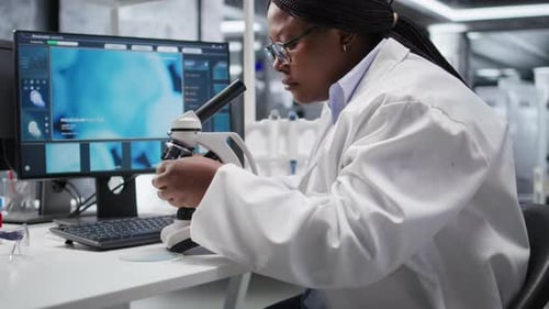 Microscope Close Up of DNA Sample Placed on Tray Under the Magnifying Glass