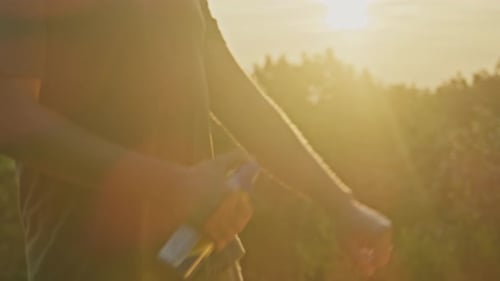 Sunset Mosquito Defense Man Sprays Repellent on Mountain