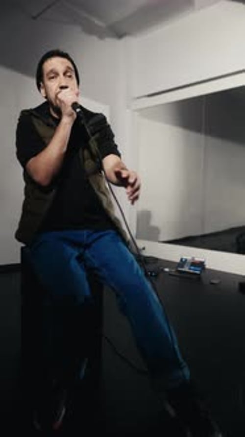 Man Sings Into Microphone Sitting Indoors