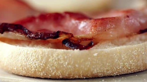Extreme Close-Up of Crispy Cooked Bacon on a Toasted English Muffin