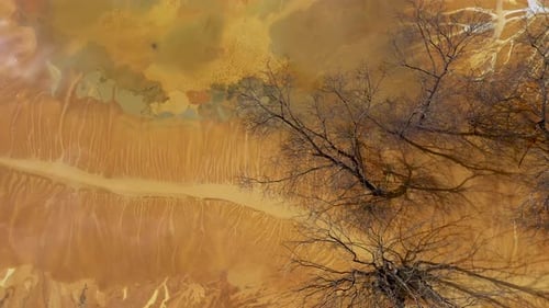 Aerial view of surreal toxic water stream from copper mine in decanting lake. Natural pattern