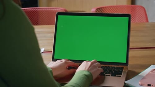 Woman Typing on Laptop with Green Screen