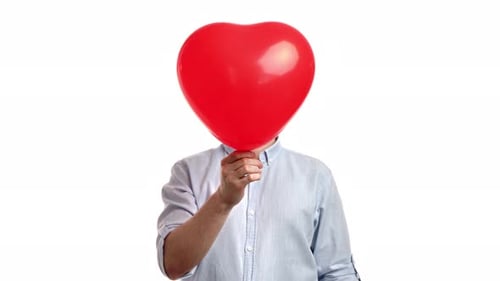 Heart-Shaped Balloon Held by Person in Blue Shirt