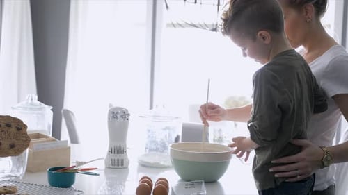 Boy and Woman Baking in Kitchen Together