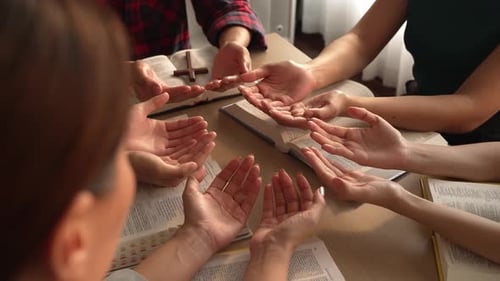 Christian group praying together with bible. Burgeoning