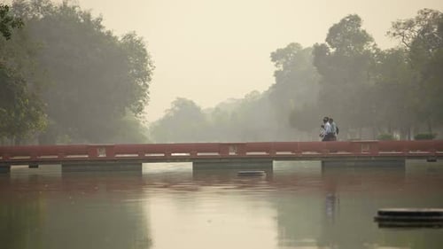 Indian people passing a bridge