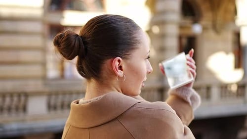 Young Woman Looking in Compact Mirror to Checkup Makeup in City Centre of Prague Europe
