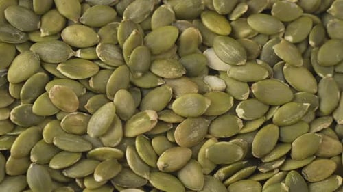 Green fresh Pumpkin seeds closeup shot.