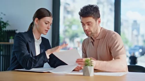 Business Colleagues Reviewing Documents in Bright Office