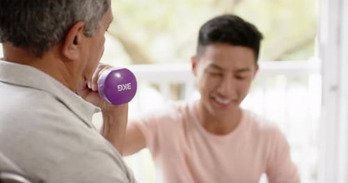 Senior Working Out with Weights with Adult Friend
