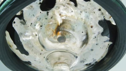 Liquid Transformation in Glass Bowl: Macro Abstract View