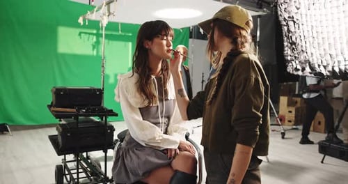 Cosmetics, beauty and cosmetologist with model in studio for photoshoot, filming or production