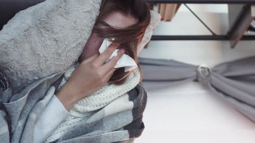 Woman Lying Down with Cold and Flu Symptoms