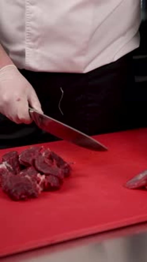 Chef Cuts Raw Meat on Cutting Board