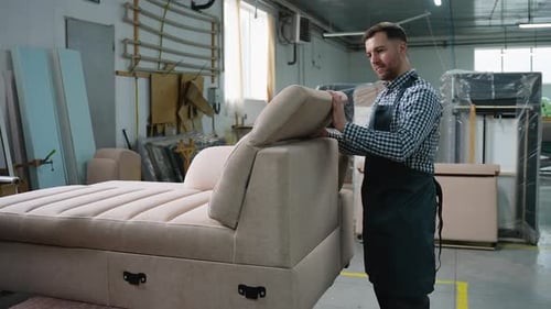 Man Assembling Adjustable Sofa Backrest in Workshop