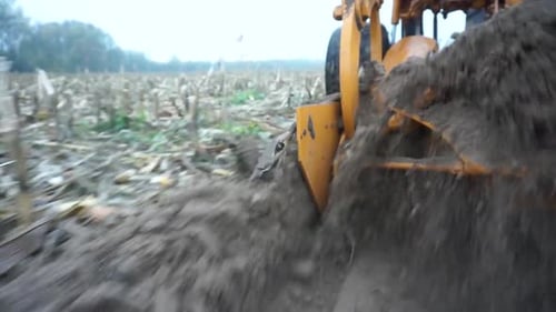 Red tractor plowing the field in Ukraine