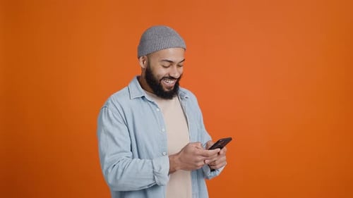 Excited Man Celebrating While Using Smartphone