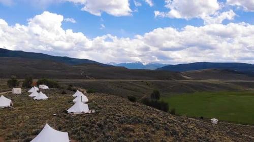 Aerial ascending shot over big camping tents in the National Park of Estes in Colorado.
