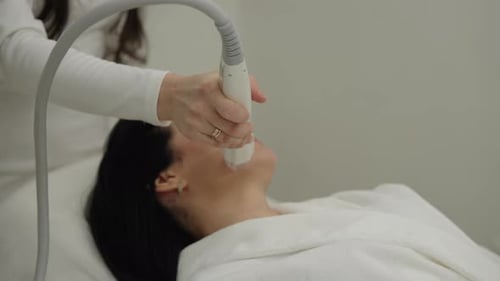 Professional Cosmetologist Performing Microneedle Rf Lifting Procedure on Client Face for Skin