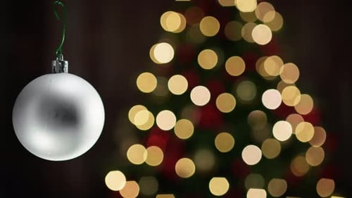 White Christmas Ornament with Defocused Lights Background
