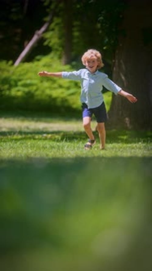 Happy Child Running Joyfully in Green Field