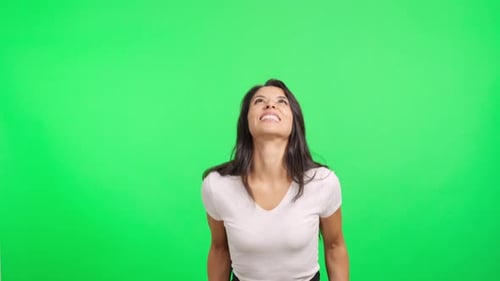 Happy Young Woman Celebrating with Confetti Falling on Green Screen
